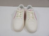 white sneakers with pink trims and laces on a white surface