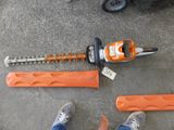 a person standing next to a chainsaw and a pair of shoes