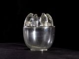 a glass cup with ice inside of it on a table