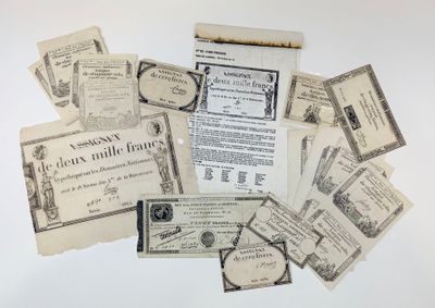 a pile of old papers and old money on a table
