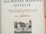 inscribed book on a wooden table with a picture of a house