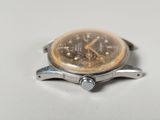 a watch that is sitting on a white surface
