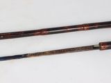 two different types of golf clubs on a white surface