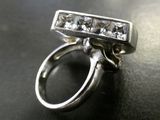 a silver ring with a bunch of diamonds on it