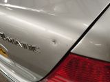 a close up of a car ' s tail light with the name of a company on it