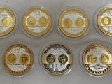 six gold and silver coins with different designs on them on a white surface