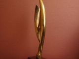 sculpture of a woman ' s head on a pedestal in front of a red wall