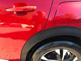 a close up of a red car with a black rim