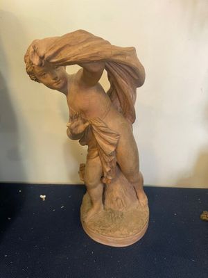 a statue of a woman carrying a bag on her head