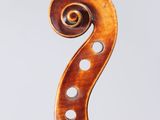 an antique violin with a scroll and a bow on a white background