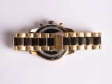 an image of a close up of a watch on a white surface
