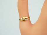 a woman ' s hand with a gold ring on it