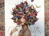 a poster with a picture of a woman with butterflies on her head