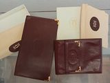 three leather wallets are sitting on a glass table next to each other