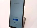 the back view of a smartphone with a blue button on the screen