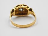 a gold ring with a diamond set in the center