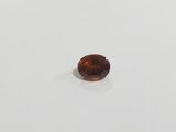 a close up of a brown diamond on a white surface