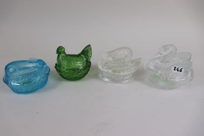 three different colored glass items sitting on a table