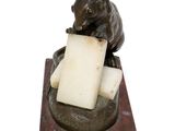 a statue of a mouse holding a piece of cheese