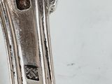 a close up of a silver spoon on a table