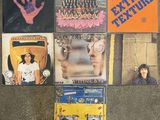 a lot of different album covers on the floor