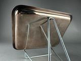 a metal magazine rack with a magazine holder on it