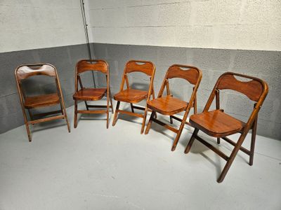 five chairs lined up in a circle in a room
