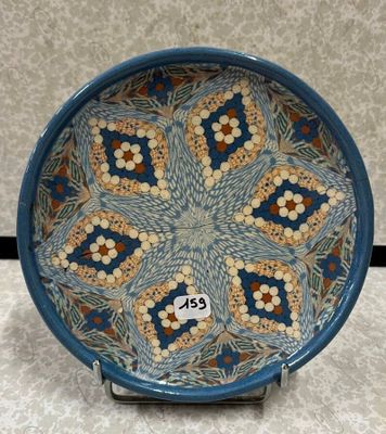 assiette décorative bleue et marron ornée d'un motif floral