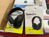 two boxes of headphones and a keyboard on a table