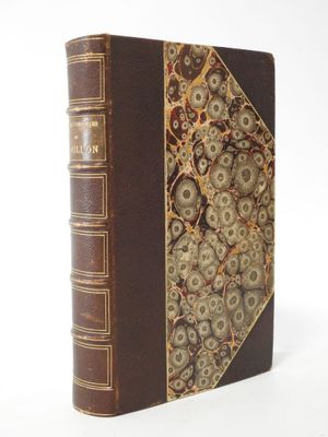 an old book with gears on it sitting on top of a white surface