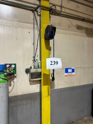 a yellow pole with a sign on it in a garage