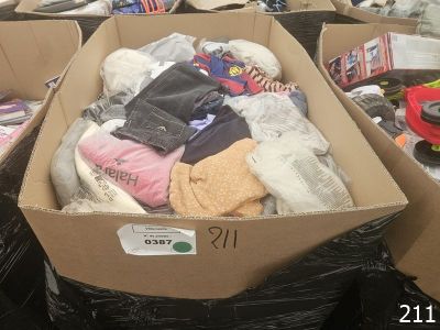 a cardboard box full of clothes and other items