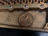 a close up of a musical instrument with a coin on it