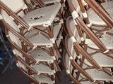 a lot of chairs that are stacked on top of each other