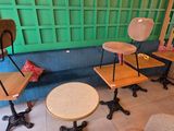 many chairs and tables in a room with a green wall
