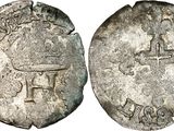a silver coin with an image of a man on it