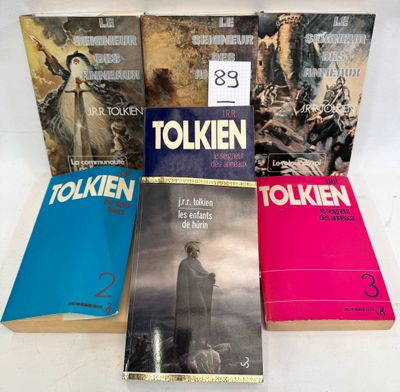 four books are stacked on top of each other on a table