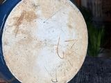 a blue and white drum sitting on top of a wooden table
