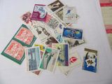 a pile of stamps on a white table cloth