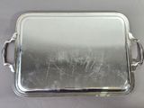 silver plated serving tray with handles and handles on a table