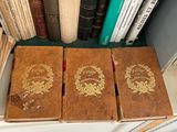 three books that are sitting on a shelf next to each other