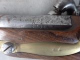 a close up of a gun on a wooden table