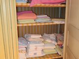 a closet with a lot of folded towels on it