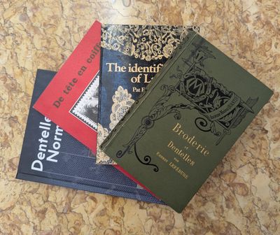 three books sitting on top of each other on top of a table