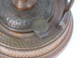 a close up of a metal object on a white surface