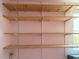 a room with a shelf and a window in it