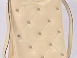 a white purse with silver stars on it and a strap