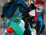 a basket full of clothes that is sitting on the floor