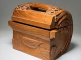 a wooden box with a carved design on the lid