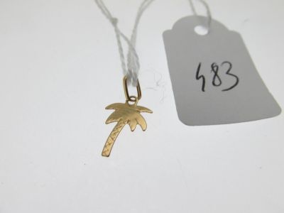a gold palm tree charm with a price tag on it